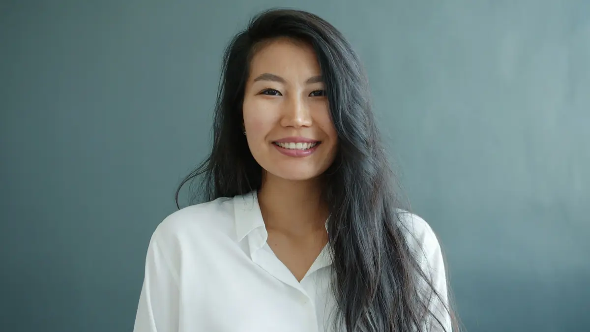 June Takahara, founder of Halden, smiling in a white shirt