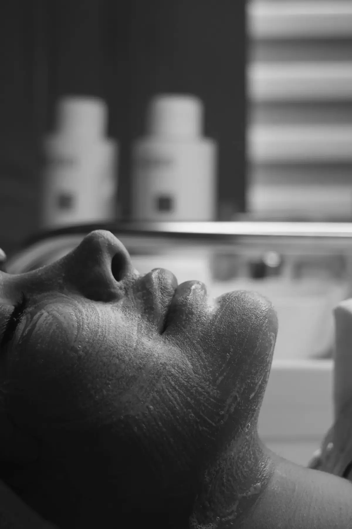 A client resting with a cleansing mask on her face